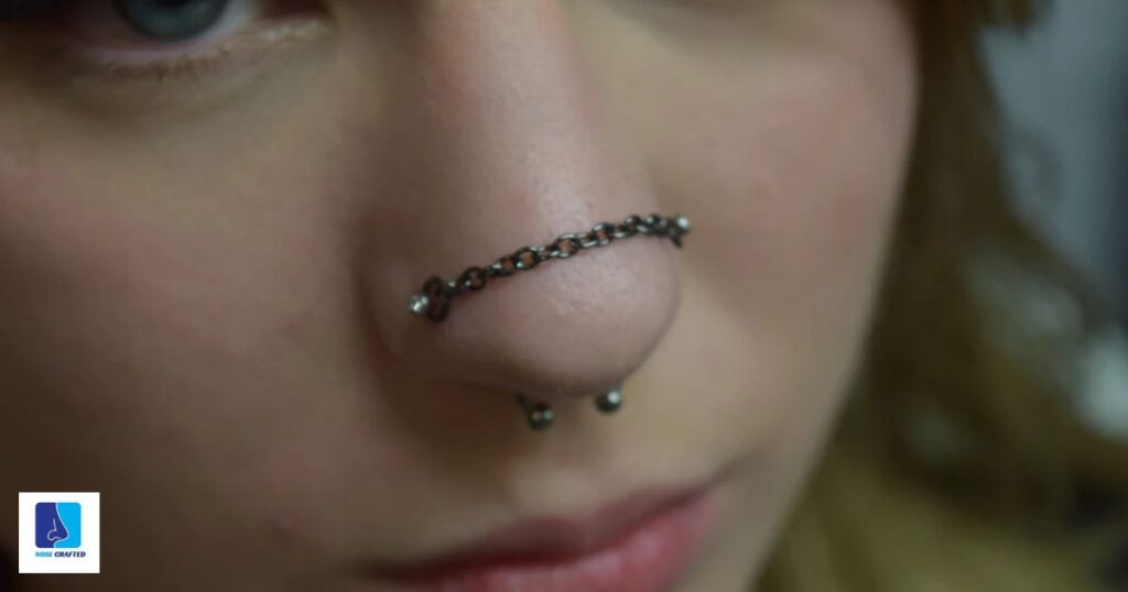 nose piercing on both sides with chain